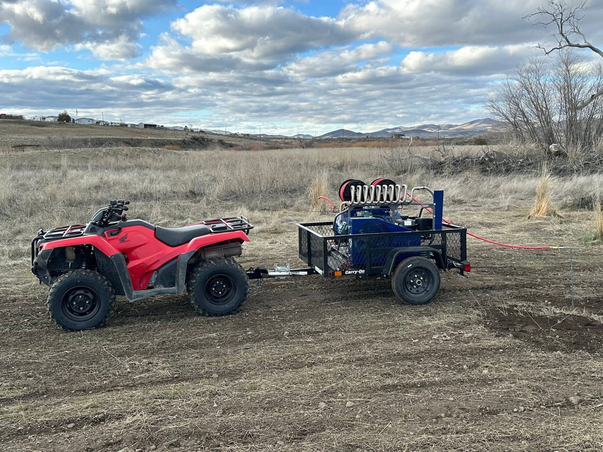 PERC fumigation rig on trailer behind ATV in an Idaho field